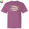 A heathered purple short-sleeve t-shirt with a colorful graphic on the chest that reads 'DOGS MAKE ME HAPPY' surrounded by Halloween-themed illustrations. A circular multicolor color wheel icon is visible in the top-left corner.