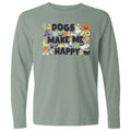A sage green long-sleeve t-shirt with a colorful graphic on the chest that reads 'DOGS MAKE ME HAPPY' surrounded by Halloween-themed illustrations like a jack-o'-lantern, witch hat, candy corn, and ghosts.
