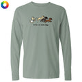 A sage green long-sleeve t-shirt with a graphic of a cat chasing three dogs and the text 'let's run some k9s' printed on the chest, displayed on a clean white background.
