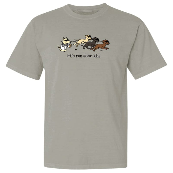 A light gray crewneck t-shirt featuring a cartoon graphic of a white cat chasing three dogs with the text 'let's run some labs' printed below.