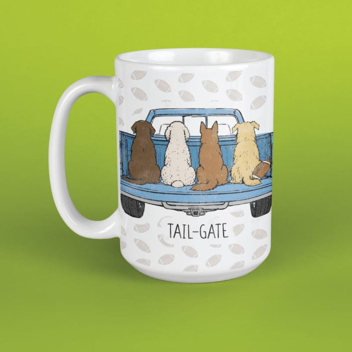 A white ceramic mug featuring a printed illustration of four dogs sitting in the back of a blue pickup truck, with the text 'TAIL-GATE' below. The mug is set against a solid lime green background.
