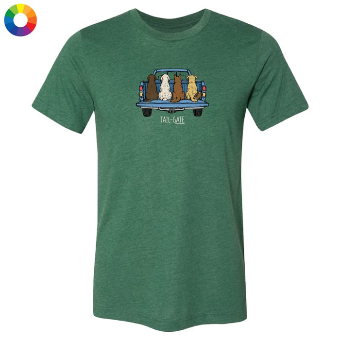 A green heathered short-sleeve t-shirt with a graphic of four dogs sitting in the back of a pickup truck, with the text 'TAIL-WIT' below. A small multicolor color wheel icon is in the top-left corner, set against a plain white background.